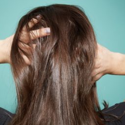 Thinning hair: Close up of scalp brunette woman thinning hair