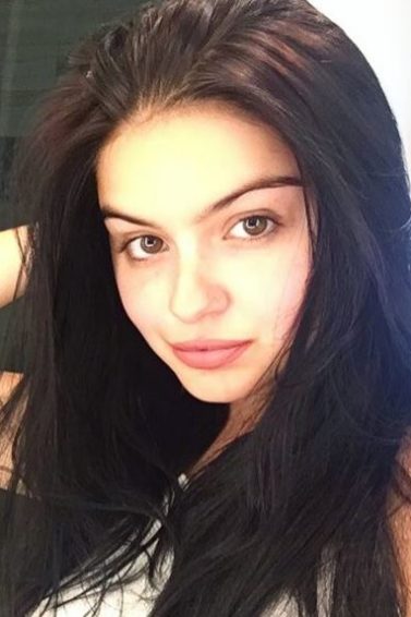 actress Ariel Winter with brown long hair talking a selfie