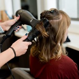 woman getting her hair styled in the salon