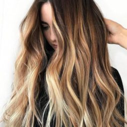 woman with very long wavy brown ombre hair