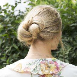 Banana bun hair style tutorial blonde girl standing outside