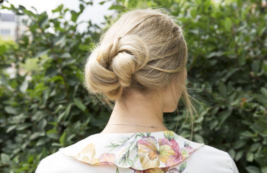 Banana bun hair style tutorial blonde girl standing outside