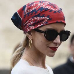 Woman wearing a red bandana and black sunglasses