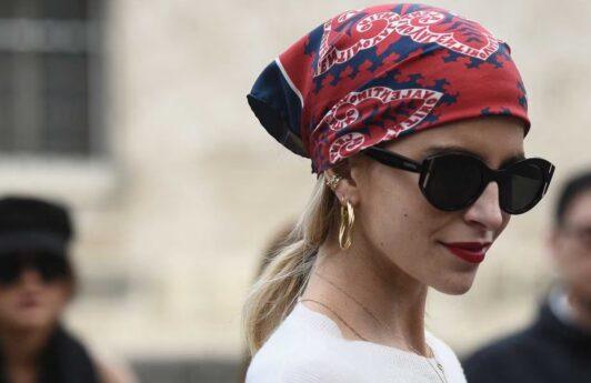 Woman wearing a red bandana and black sunglasses