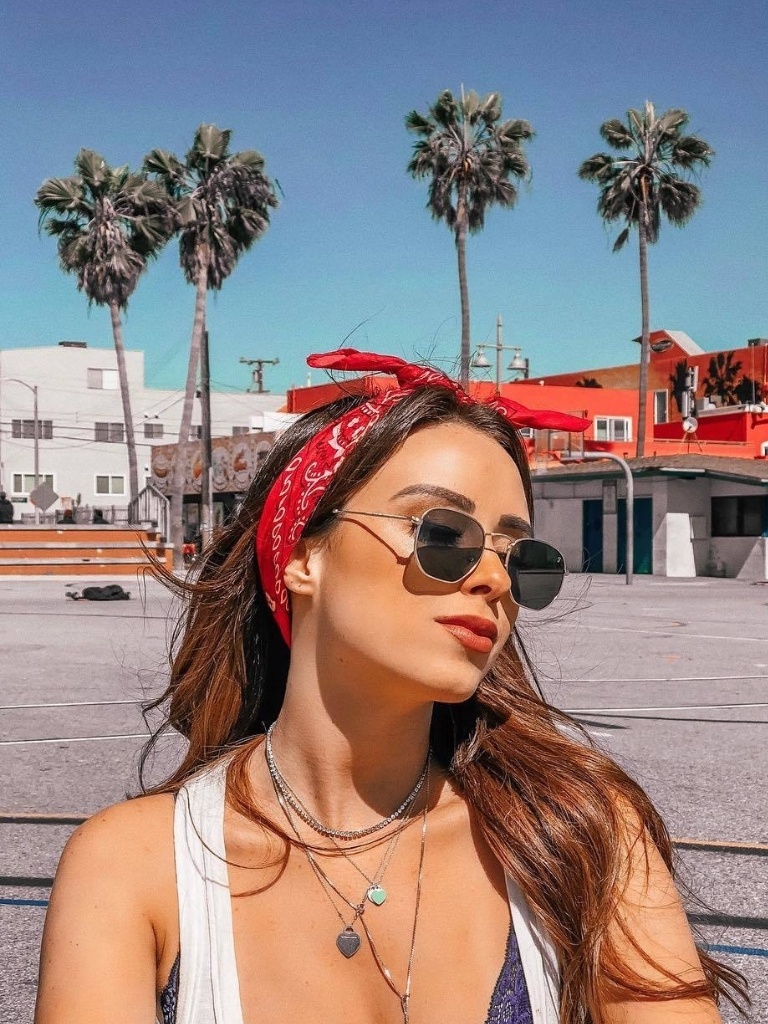 Woman wearing a bandana outdoors on a sunny day