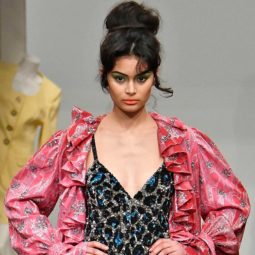 easy vintage hairstyles: close up shot of model on the ashish runway with 60s style volumised bun updo, wearing pink dressing grown and sparkly slip dress