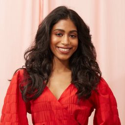 Woman with long dark brown hair styled into beachy waves