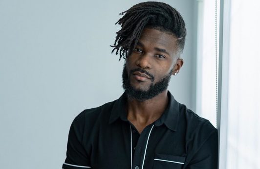 Black man with side-swept dreads and drop fade haircut