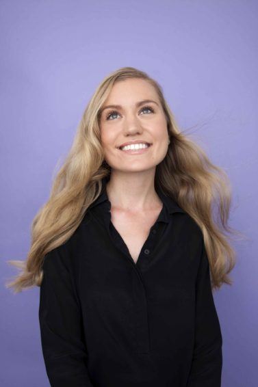 front view image of a woman with long wavy blonde hair - volume hair