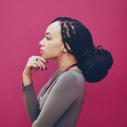 a dreadlock long hair sexy woman on a red background