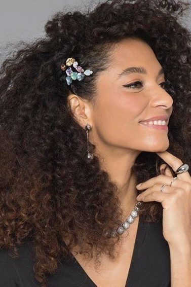 Woman with naturally curly hair with hair accessories