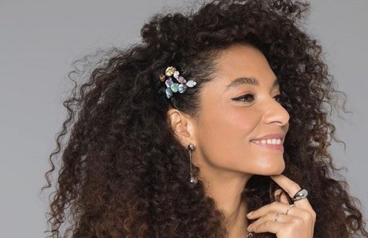 Woman with naturally curly hair with hair accessories