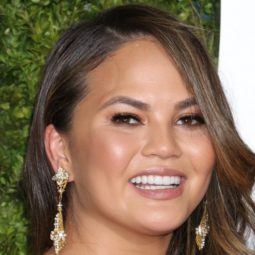 model chrissy teigen with sideswept curly hair