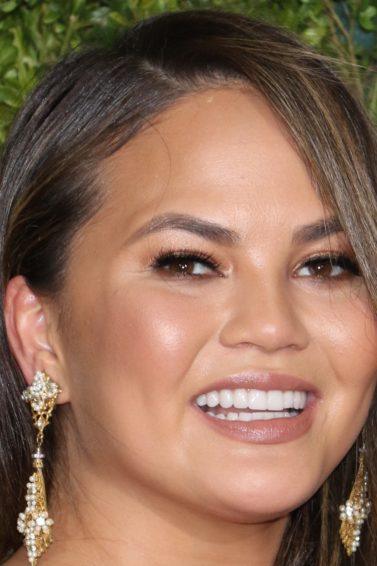 model chrissy teigen with sideswept curly hair