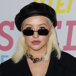 singer christina aguilera with a platinum lob and black beret hat