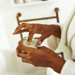 woman with coconut oil in her hand