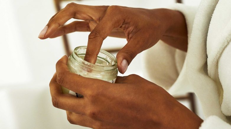 woman with coconut oil in her hand