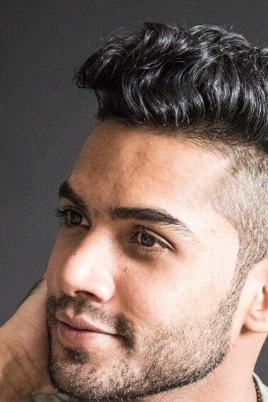 man with a faded undercut hairstyle looking away from the camera