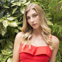 How to curl your hair with a curling wand: Final look of blonde model wearing a red dress