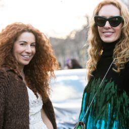 woman with red curly hair and another with blonde