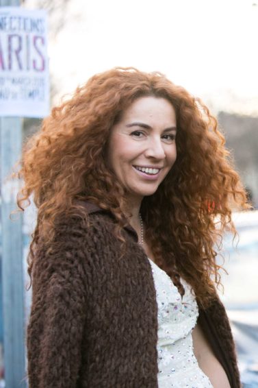 woman with red curly hair and another with blonde