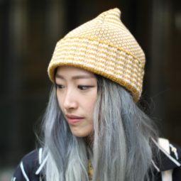 Best deep conditioner for damaged hair: Woman with grey long hair under wolly hat street style.