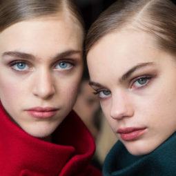 models with slick precise part hairstyle backstage carolina herrera