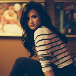 demi lovato long black hair sitting in a bedroom