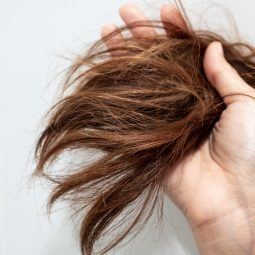 Woman holding her dry hair