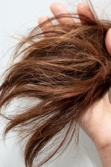 Woman holding her dry hair