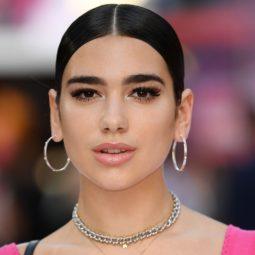 singer dua lipa with slick back brunette hair with a centre parting