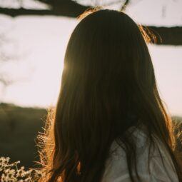 Woman with fine hair in a field.