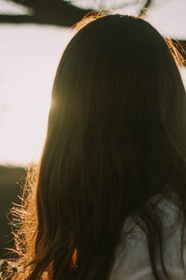 Woman with fine hair in a field.