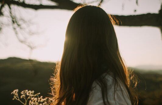 Woman with fine hair in a field.