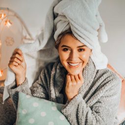 International women's day empowerment: Em Sheldon sitting down with her wrapped in a towel