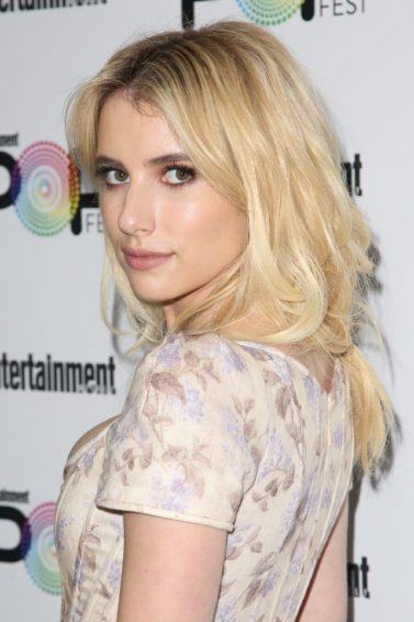 emma roberts wearing a floral dress with bleached blonde long hair