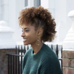 Easy hairstyles for short curly hair: Woman with afro mohawk AKA 'frohawk' on her golden brown natural hair.