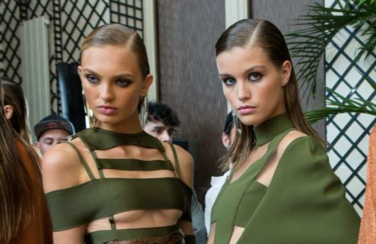 models backstage at balmain runway show with straight lwo wet look hair