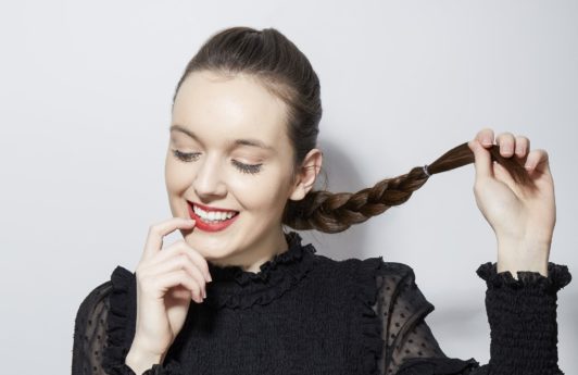 How to french braid your own hair brunette girl holding her braid