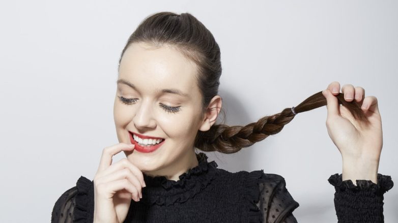 How to french braid your own hair brunette girl holding her braid