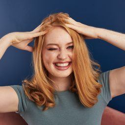 Woman touching her hair and smiling