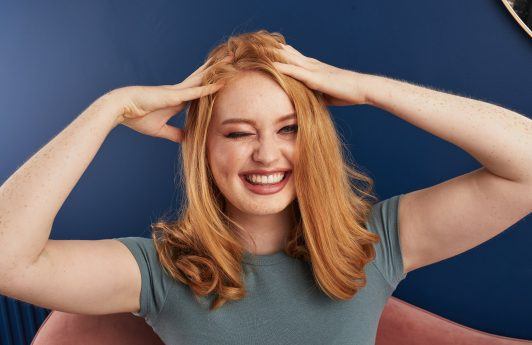 Woman touching her hair and smiling