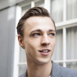 How to use hair gel brunette man standing n the street looking away from camera