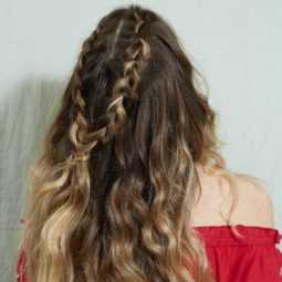 Woman with wavy brunette ombre hair in a half-up braid