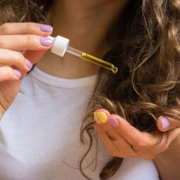 curly haired girl using hot oil treatment for hair