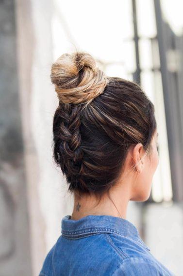 blonde woman with upside down braid wearing a denim shirt