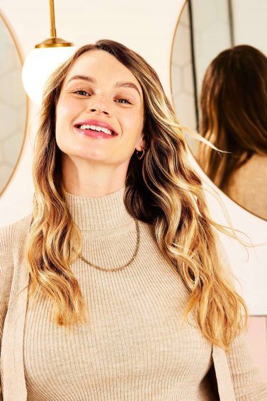 Woman with healthy, bouncy hair smiling