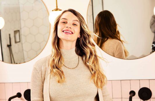 Woman with healthy, bouncy hair smiling