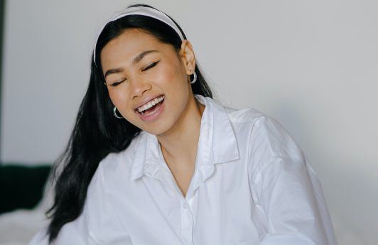 Asian woman with long hair smiling