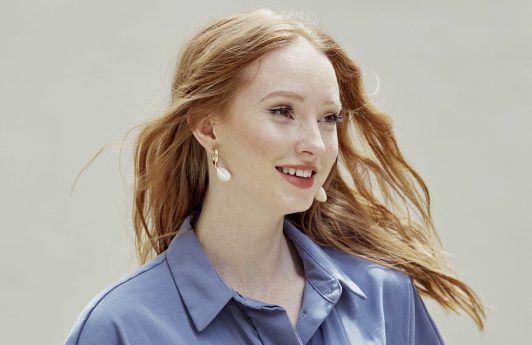 Redhead woman with long tousled waves